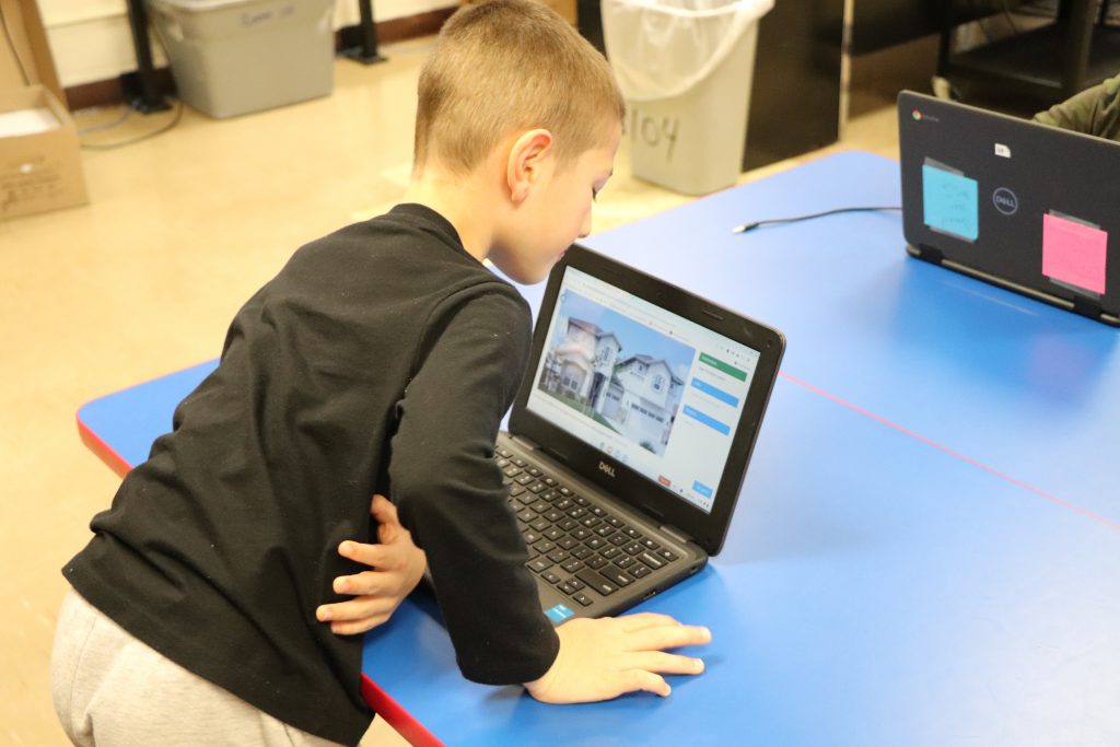 An elementary school students works on a Chromebook during the last session of the Coding Club at Goshen Intermediate School.
