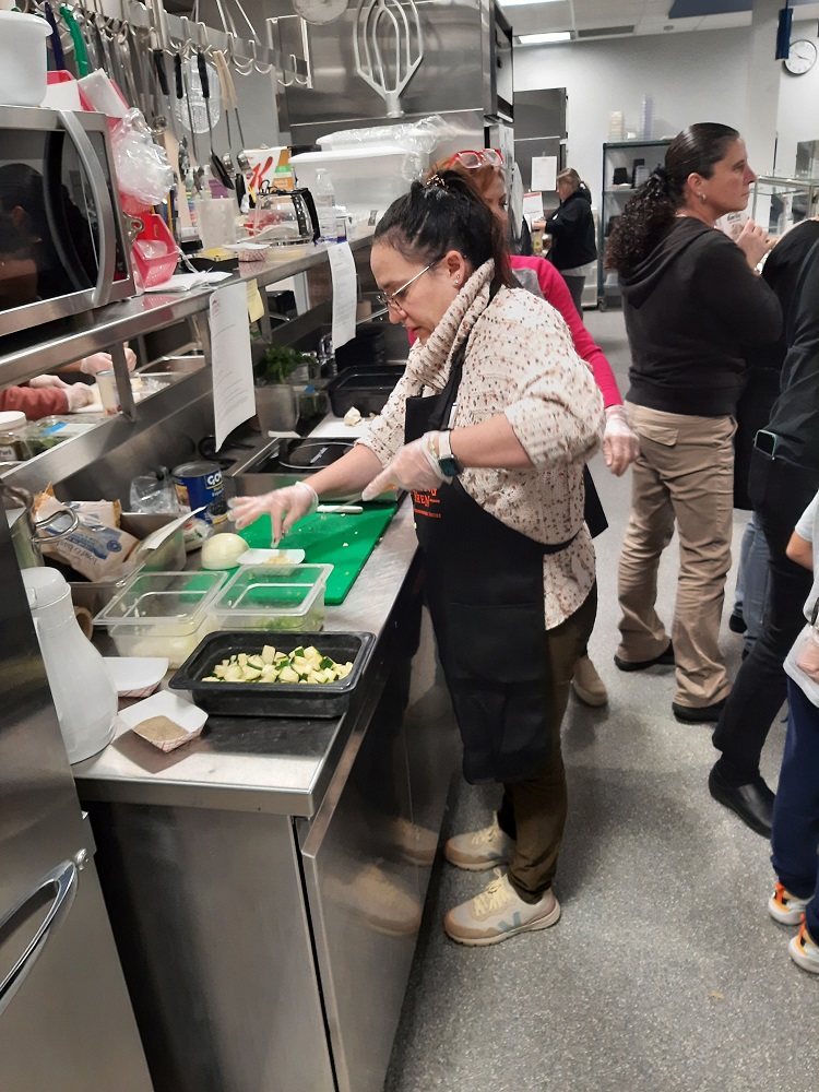 Food services staff prep vegetables at Scotchtown Avenue Elementary School during a farm-to-school recipe training.