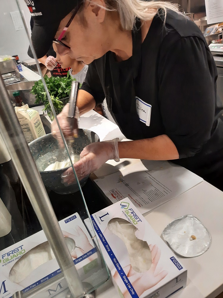 Food services staff prep for new recipes at Scotchtown Avenue Elementary School during a farm-to-school recipe training.