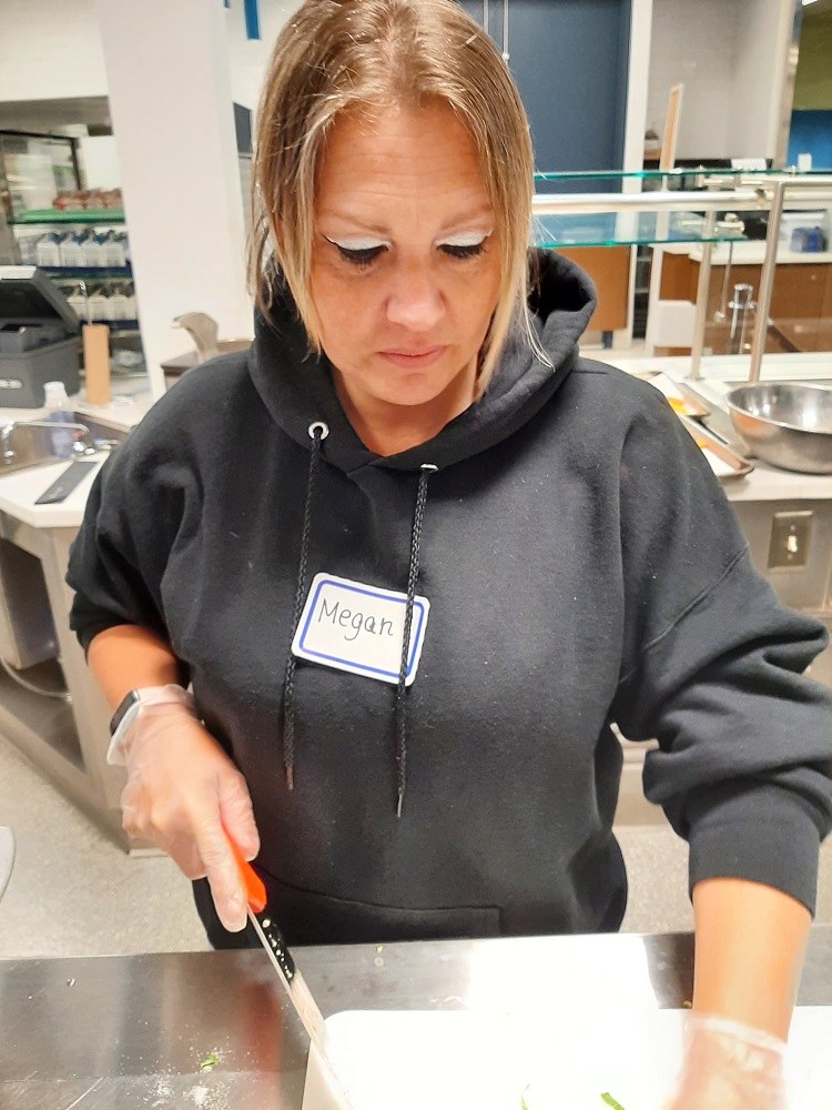 Food services staff prep vegetables at Scotchtown Avenue Elementary School during a farm-to-school recipe training.