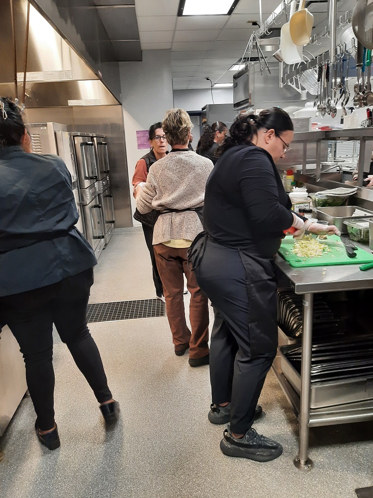 Food services staff prep vegetables at Scotchtown Avenue Elementary School during a farm-to-school recipe training.