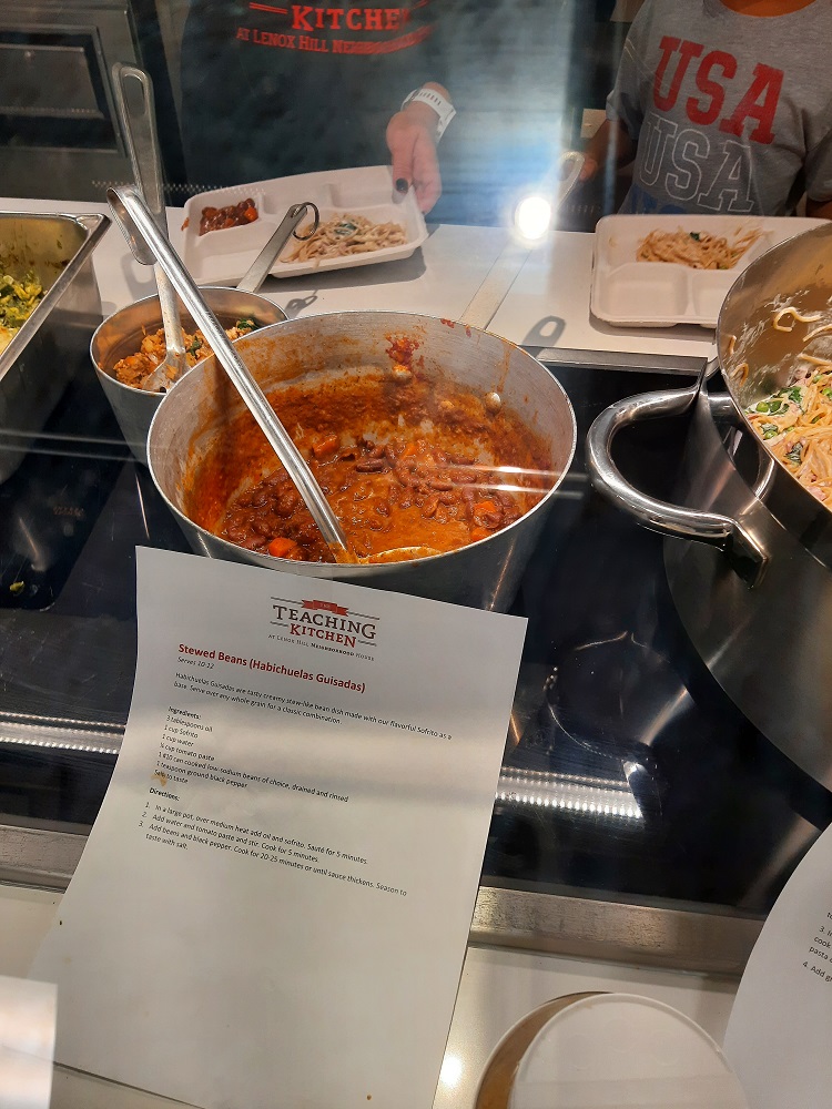 Stewed beans and spaghetti carbonara rest on a counter in pots for Food Services employees to try after a farm-to-school training at SAS.