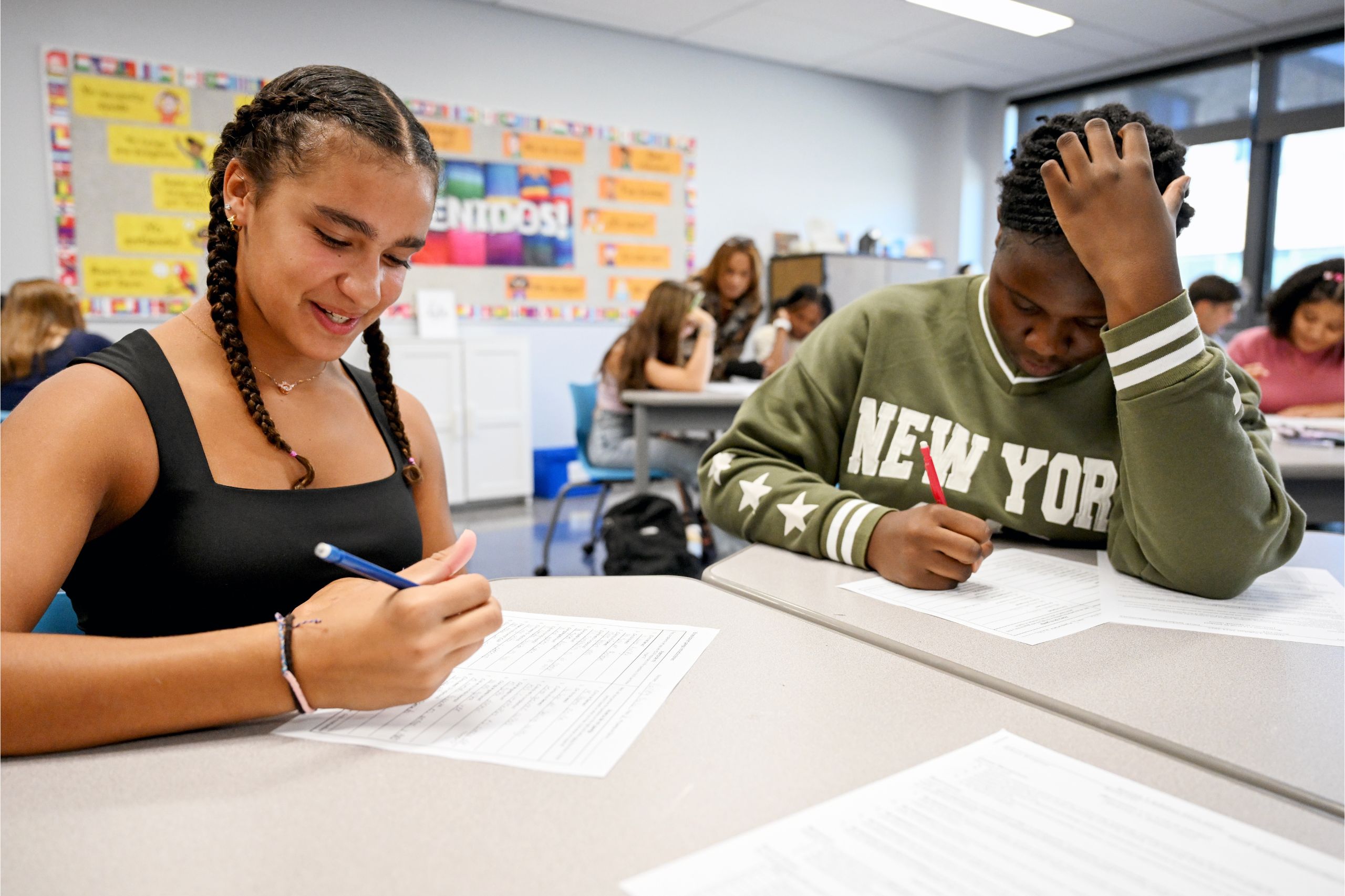 Two students sit at their desks and work on their classwork at the first day of school in Goshen High School