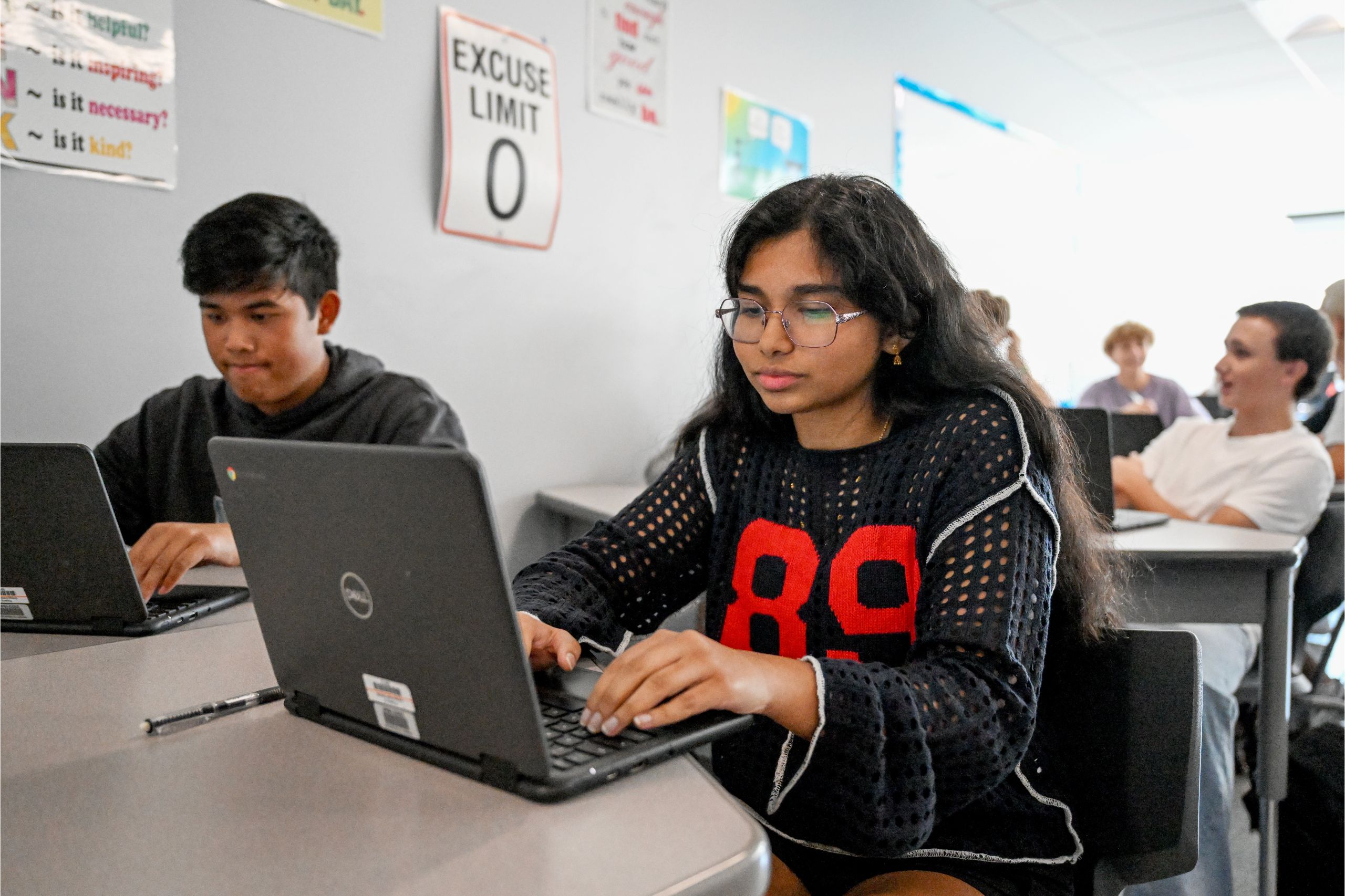 Two students work on laptops at their desk in Goshen high School.