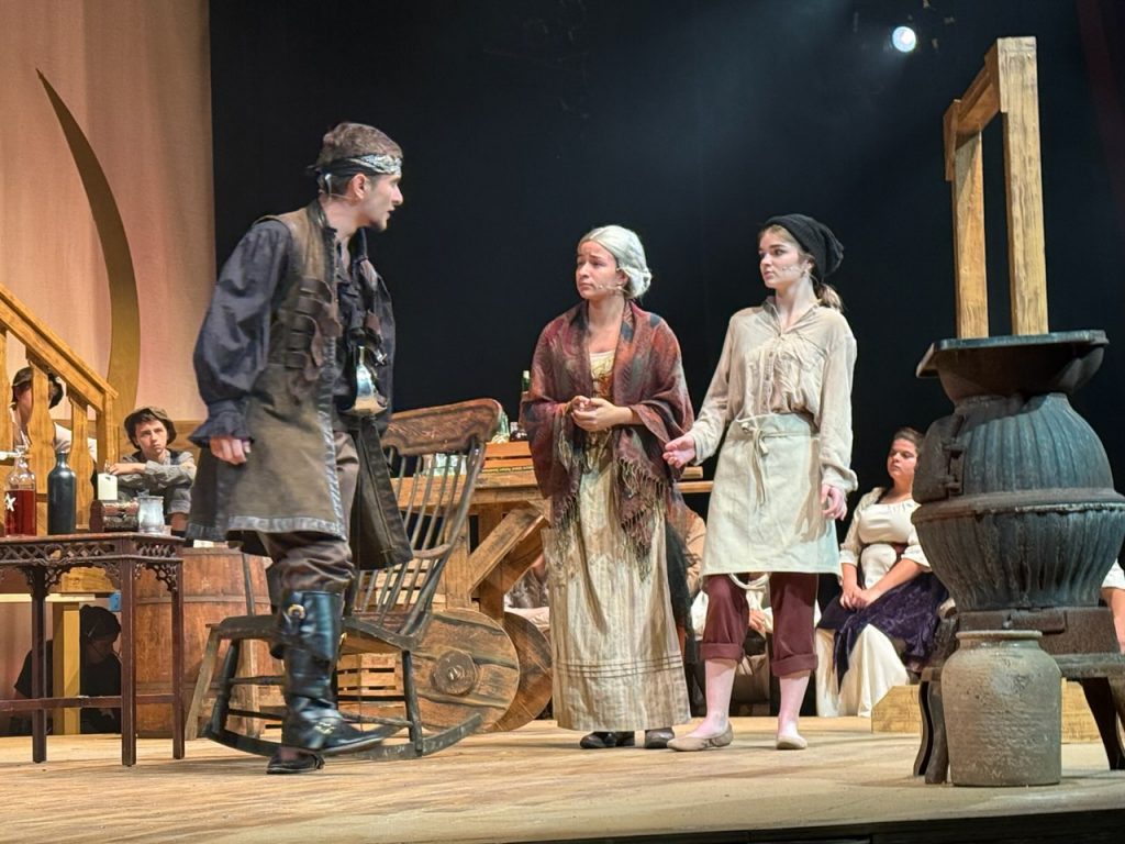 Three students, (left to right) Alex Greene, Mia Nieves and Riley Quattrini on stage during Treasure Island. 