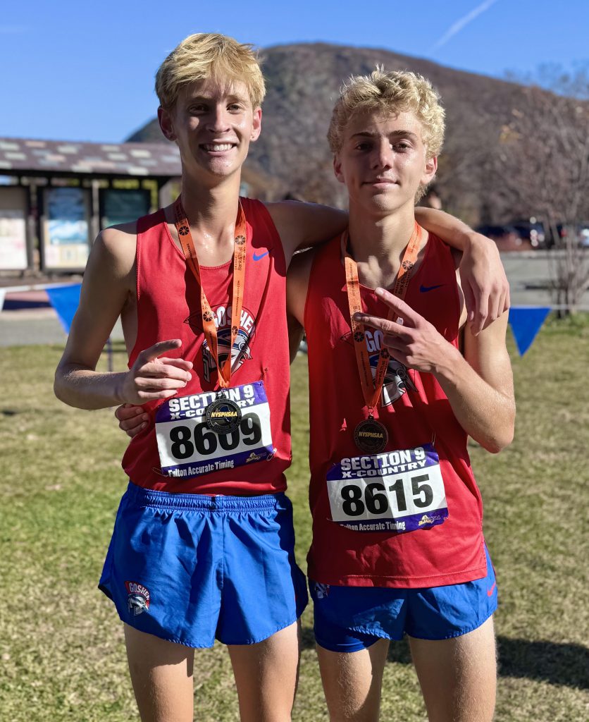 Noah Klugman and Jackson St. Lawrence stand together after a race with Section 9 medals. 