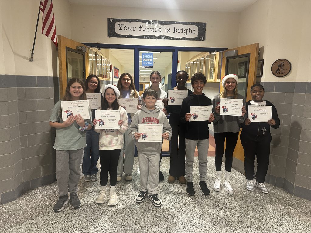 The CJ Hooker November students of the moth stand together and pose with their recognition. 