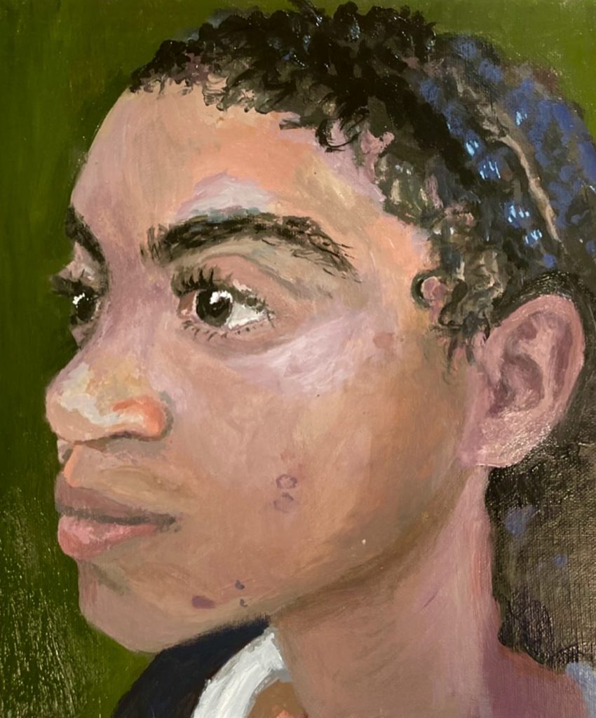 A painting of the side of a girl's face. The person is looking to the left of the painting. 