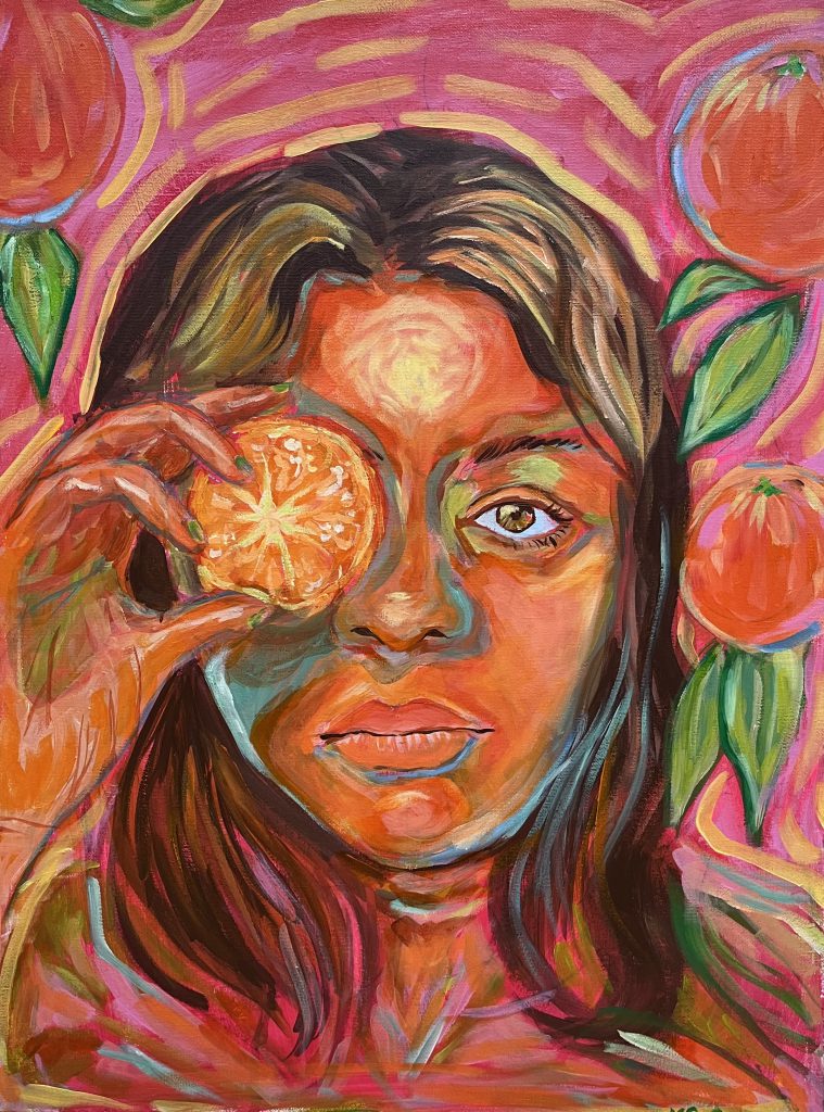 A girl holds an orange slice in front of her right eye. The picture is pink, orange, green and yellow. 